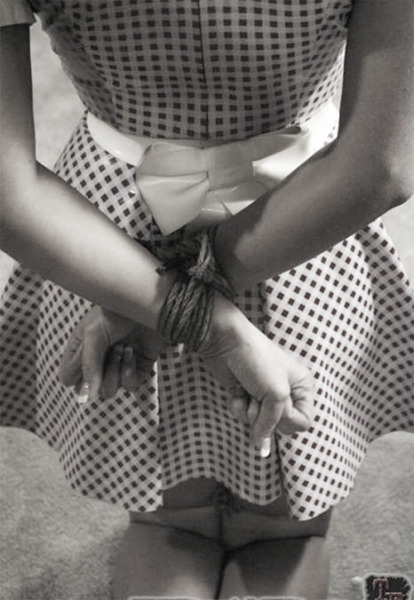 As she meekly crosses her wrists behind her back allowing them to be tied together, she realizes tha