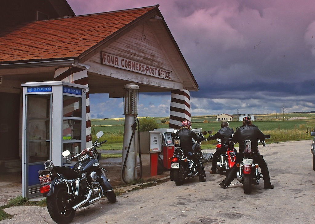Riders On The Storm. This is one of my favourite on the road shots taken on my way up to the 50th Sturgis back in 1990. Four Corners is in the middle of Wyoming and the riders are about to cross Thunder Basin and encounter a hail storm which left the...