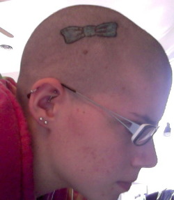 fuckyeahtattoos:  In February, my grandmother was diagnosed with breast cancer and a few weeks ago she started losing her hair because of the chemo. So I decided to shave my head for St. Baldrick’s. When I had hair, I wore bows in it a lot so I got