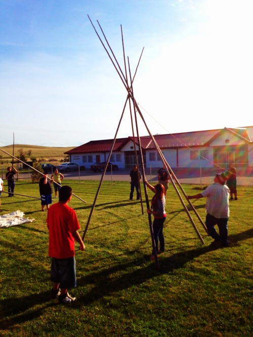 Oglala Lakota College students learning how to set up a Tipi in their Lakota Culture class.