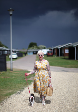 harvestheart:  Aging Rockabilly Queen Rock and Roll devotee Rebecca Butterfly walks her dog during the Hemsby Rock n Roll Weekender on May 15, 2011 in Hemsby, England. Twice a year fans of Rock and Roll, Rockabilly, Rockin’ Blues the 1950s and Americana