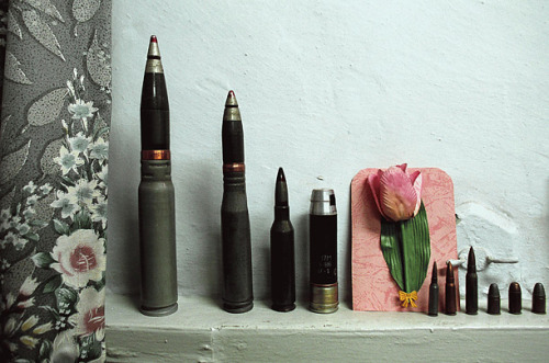A collection of bullets and a paper tulip decorate a government office in Quetta, Pakistan, 2001.Pho