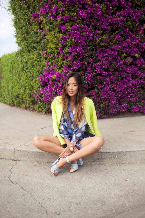 Aimee of Song of Style in a vibrant neon blazer.