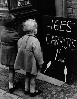  Two little girls read a board advertising carrots instead of ice lollies due to wartime shortages of chocolate and ice cream, 1941. Getty 