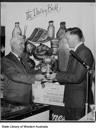 Brownes representative receiving trophy for prize winning cheddar cheese
ca.1955