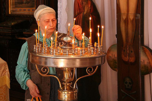 fyeaheasterneurope: Lighting candles in an Orthodox church in Lithuania.