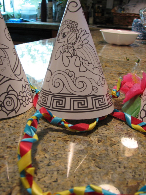diyaday:  Party time! I modified these party hats with a few simple decorations, like some rhinestones for Rarity, a large pink bow for Pinky Pie, a (not pictured) purple feather for Spike… They can easily be attached by using a hole puncher on the