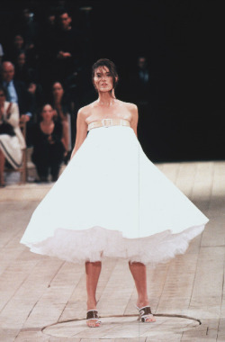 stopdropandvogue:  Shalom Harlow at Alexander McQueen Spring/Summer 1999 - No. 13  This show was inspired by the Arts and Crafts Movement and it ended with the model Shalom Harlow rotating on a turntable wearing a white dress being spray painted by two