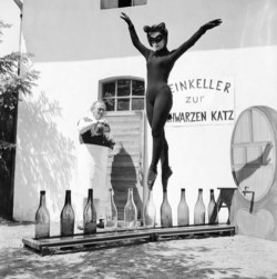 sdupreebemis:   Seventeen-year-old Bianca Passarge of Hamburg dresses up as a cat and dances on wine bottles in June 1958. Her performance was based on a dream. She practiced for eight hours a day to do this. Photo by Carlo Polito   badass. 