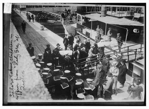 Sailors unloading the coffins of children from the Lady Grey following the sinking of the RMS Empres