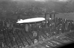 houseofhegira:  The Hindenburg flying over Manhattan (May 6, 1937) An accompanying spotter plane can be seen above the airship. This is one of the last photographs taken of the LZ-129, as it famously ignited upon landing a few hours later, killing 35