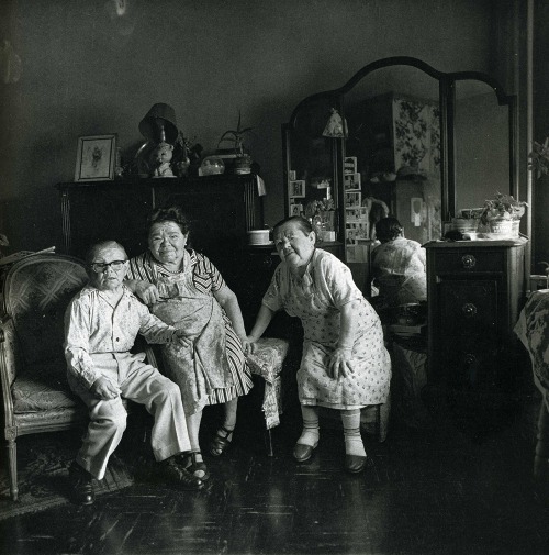 Diane Arbus – Russian midget friends in a living room on 100th Street, N.Y.C., 1963.