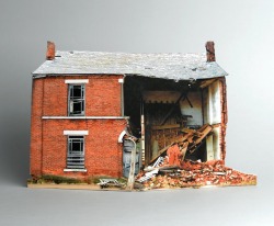 showslow:  Old, dilapidated buildings are usually an unsightly scene. In this case, however, miniature broken down houses are appreciated for being wonderful works of art. The series itself is based on photographs of abandoned structures neglected by