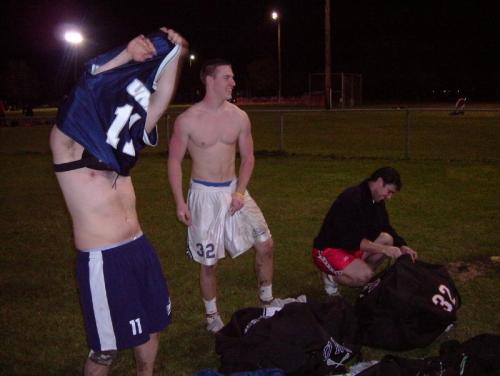 Football jocks, stripping down on the field.