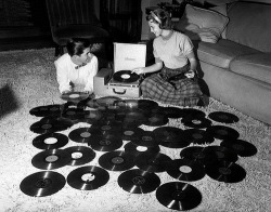  Young couple playing records spread out