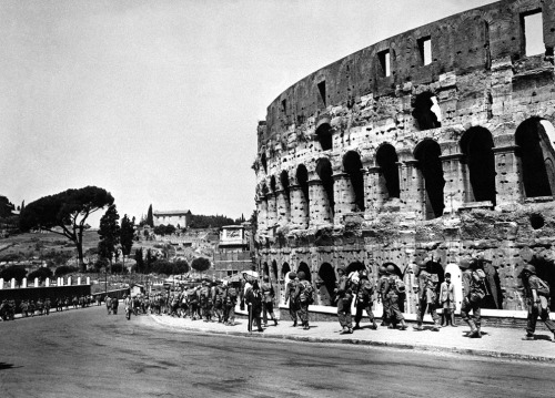 picturesofwar:“U.S. soldiers march past the historical Roman Colosseum and follow their retreating e