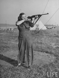 Woman testing a new type carbine at Aberdeen Proving Ground, 1942. Photo by Myron Davis.