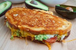 darkchef:    Bacon, Guacamole Grilled Cheese Sandwich  Ingredients 2 slices bacon 2 slices sour dough bread 1 tablespoon butter, room temperature &frac12; cup jack and cheddar cheese, shredded 2 tablespoons guacamole, room temperature 1 tablespoon tortill
