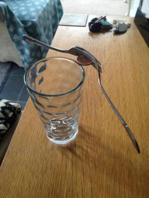 xtremecaffeine:  snakesonajames:   Because of the weight of the ends of the forks, and how they’re distributed behind the penny (closer to the glass), the center of gravity of the whole system is actually shifted quite significantly. If I’m right,
