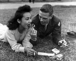  A soldier and a local girl share a chocolate bar and cigarettes, 1946. 