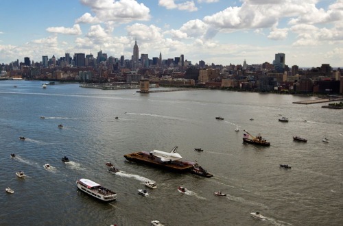 The Space Shuttle Enterprise floats up the Hudson River June 6, 2012, as it rides past the New York 