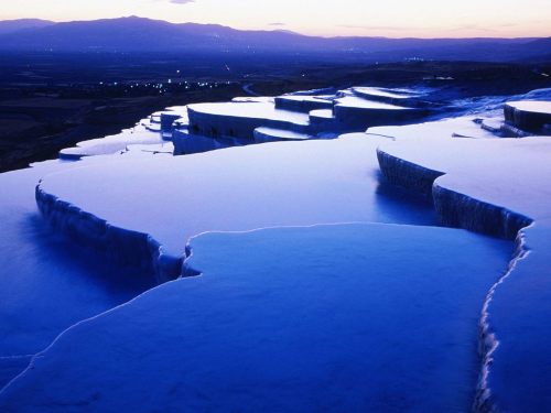     Pamukkale, Turkey, is home to hot springs that flow downhill and leave mineral deposit