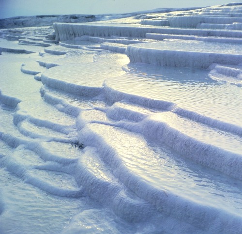     Pamukkale, Turkey, is home to hot springs that flow downhill and leave mineral deposits that bui