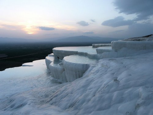     Pamukkale, Turkey, is home to hot springs that flow downhill and leave mineral deposits that bui