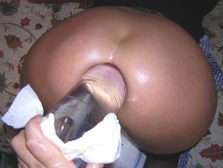 bottlefucking:  Huge clear plastic bottle opening up her asshole. 