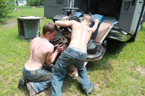 Shirtless redneck bros, using their muscle.