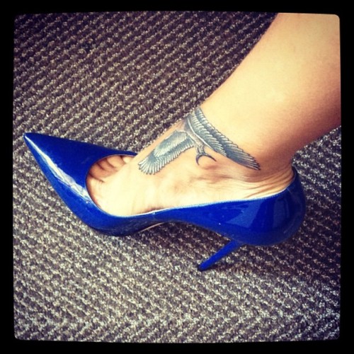 Rih Rih in blue stilettos showing off her new ankle tatt.