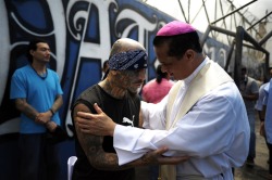 politics-war:  Catholic priest Fabio Colindres speaks with a member of Mara Salvatrucha gang during a mass at the prison of Ciudad Barrios, El Salvador on Tuesday, June 19, 2012.