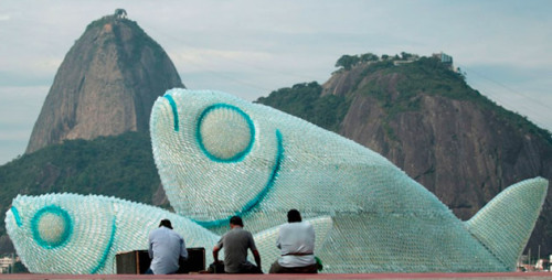 danceabletragedy: razorshapes: A fish sculpture constructed from discarded plastic bottles rises out