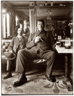 Big man enjoying a cigar and glass of beer in a New York tavern circa 1908.