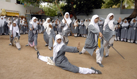 liberated-soul:  Muslim schoolgirls from St. Maaz high school practise Chinese wushu martial arts inside the school compound in the Indian city of Hyderabad. Girls from ages 10 to 16 participate in weekly sessions during school term. Source: 1, 2. 
