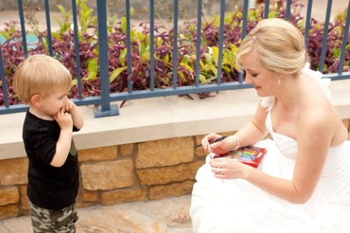 :  “On Disneyland bride Kristie’s wedding day, a tiny tot approached her with his autograph book in tow- he thought she was a Disney princess (rightfully so, she looked stunning!) and was determined to get her autograph. Kristie of course obliged