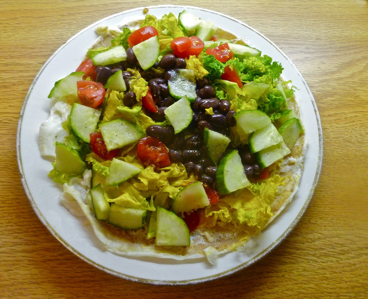 lovely lunches: abridged huevos rancheros (toasted tortilla with melted cheddar flavoured rice cheese and a fried egg topped with sauteed kale and zucchini, black beans, tomatoes and cucumber (with light salt and pepper)