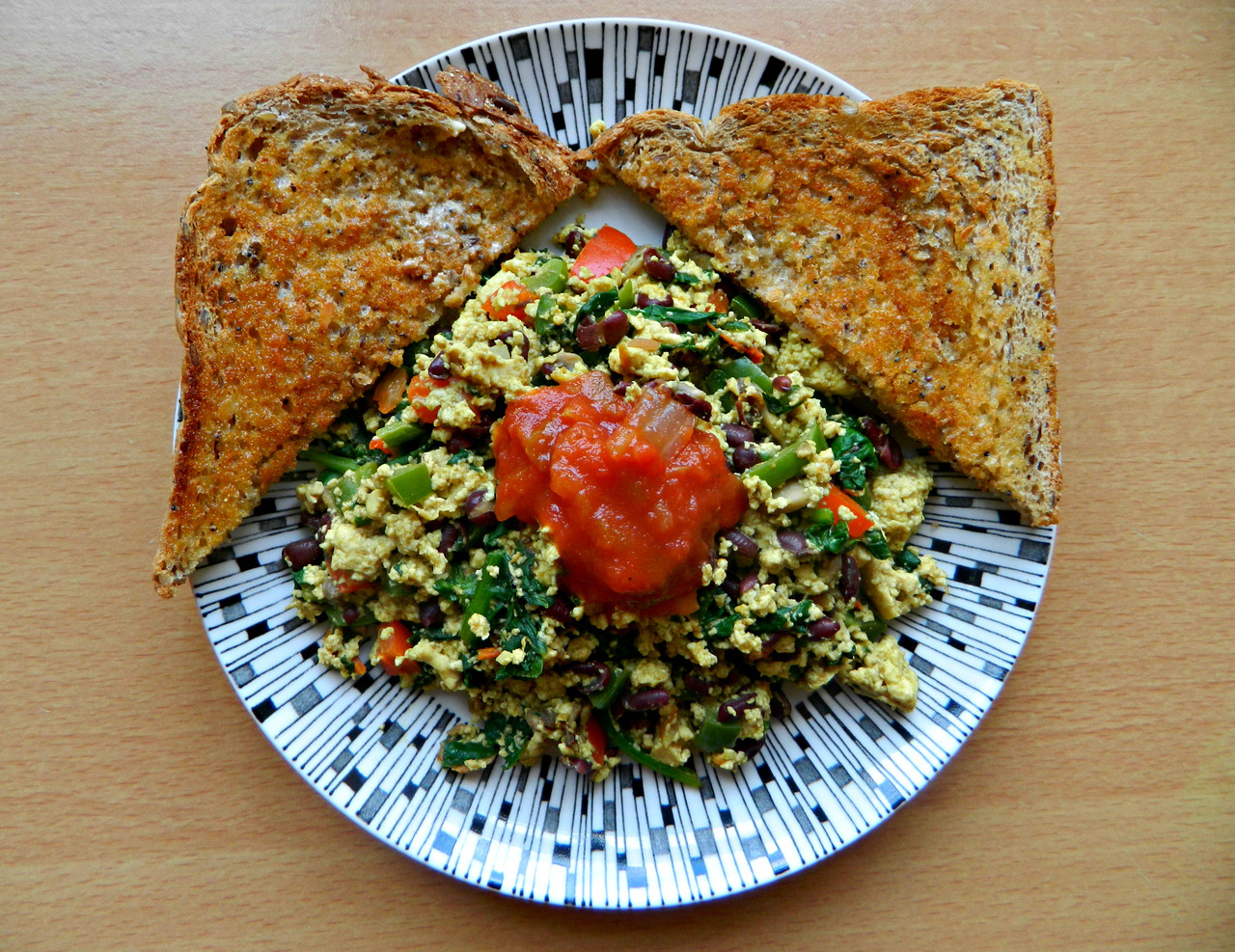 Dinner tonight… Tofu scramble (tofu, spinach, red bell pepper, cherry tomatoes, mushrooms, aduki beans, garlic, nooch, cumin, basil, turmeric, s&p) with tomato salsa and wholewheat toast with sunflower spread.