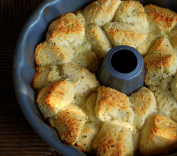  Garlic Parmesan Pull-Apart Bread  1 can of refrigerated Grands biscuits (not the flaky layers)&frac12; stick of butter3 cloves of garlic, minced&frac12; cup grated Parmesan cheese1 tsp Italian Seasoning Preheat the oven to 350 degrees. Throw the cold