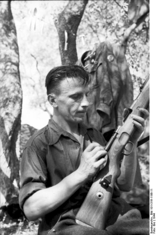 Italian soldier cleaning his rifle, Italy, ca. 1944 