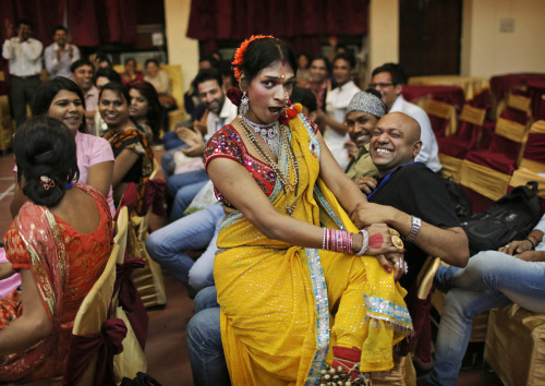 fuckyeah-india-blog:  An Indian dancer from the transgender community sits in the lap of a participa