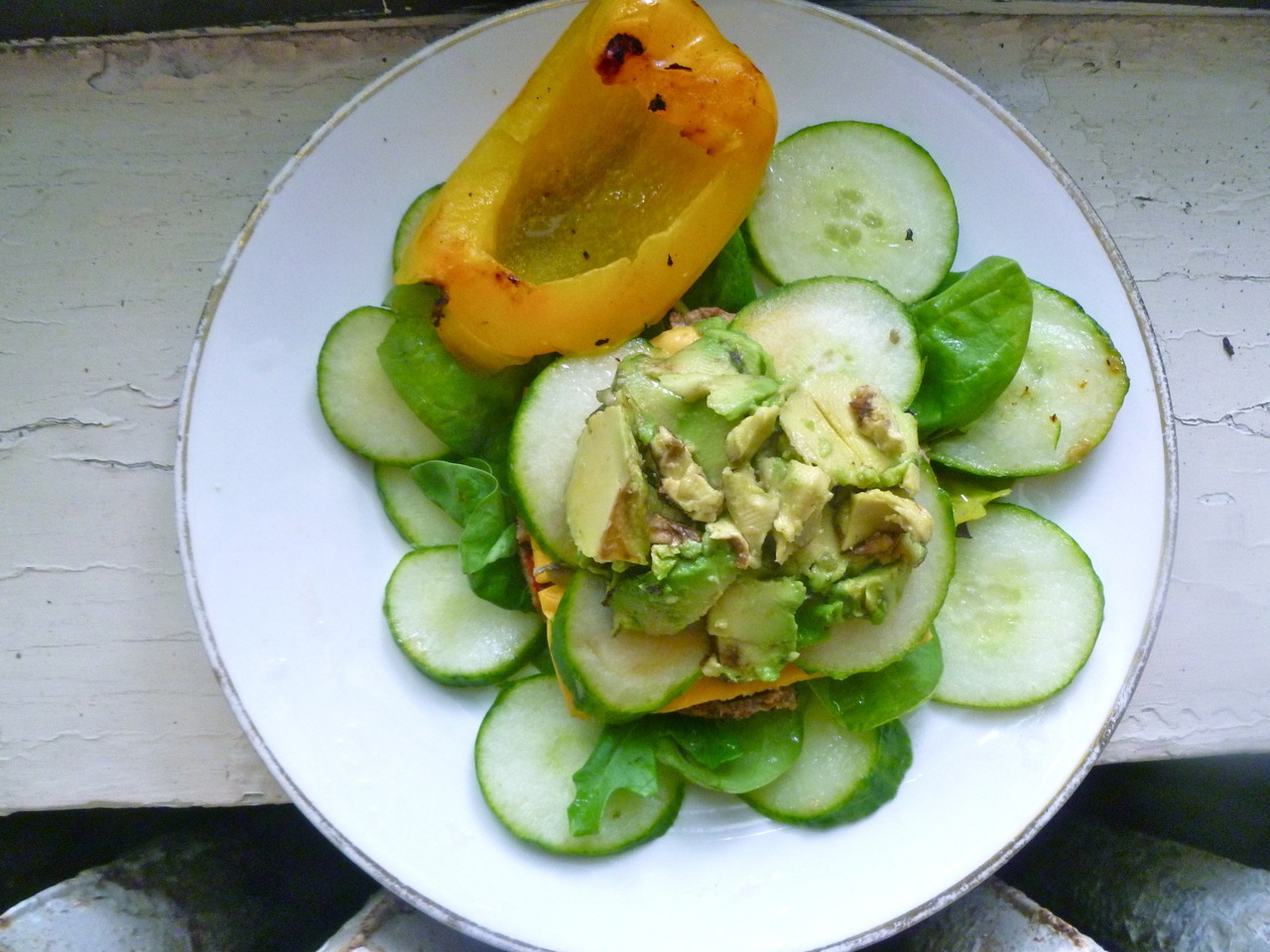 lovely lunches: avocado, cucumber, melted cheddar flavoured rice cheese on a Franklin Farms’ Portabella Veggie Burger with spinach (and more cucumbers) and a sauteed sweet bell pepper