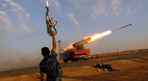 GRAD A Libyan rebel cheering on as a truck mounted with a BM-21 GRAD missile launcher. The Libyan mi