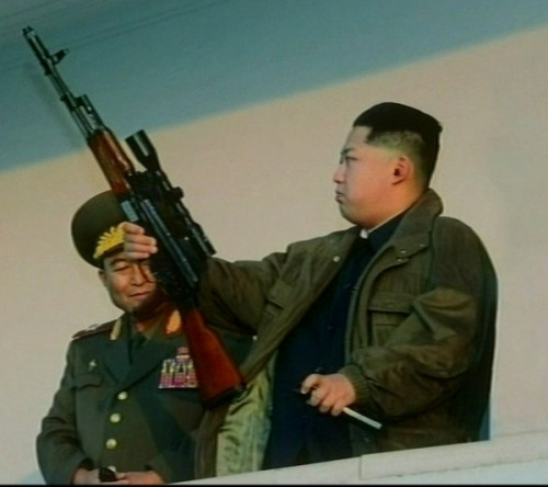 Kim Jong Un, son of deceased Kim Jong Il and current evil dictator of North Korea, inspects a scope 