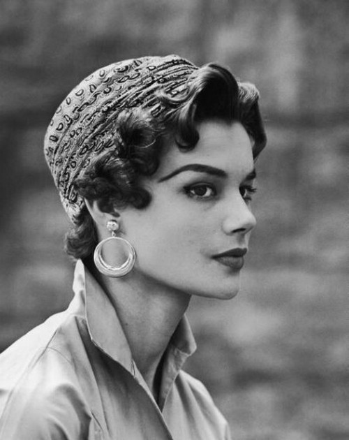 theniftyfifties:  Model wearing the new short, curled hair style fashion with a paisley turban, June 1953. 