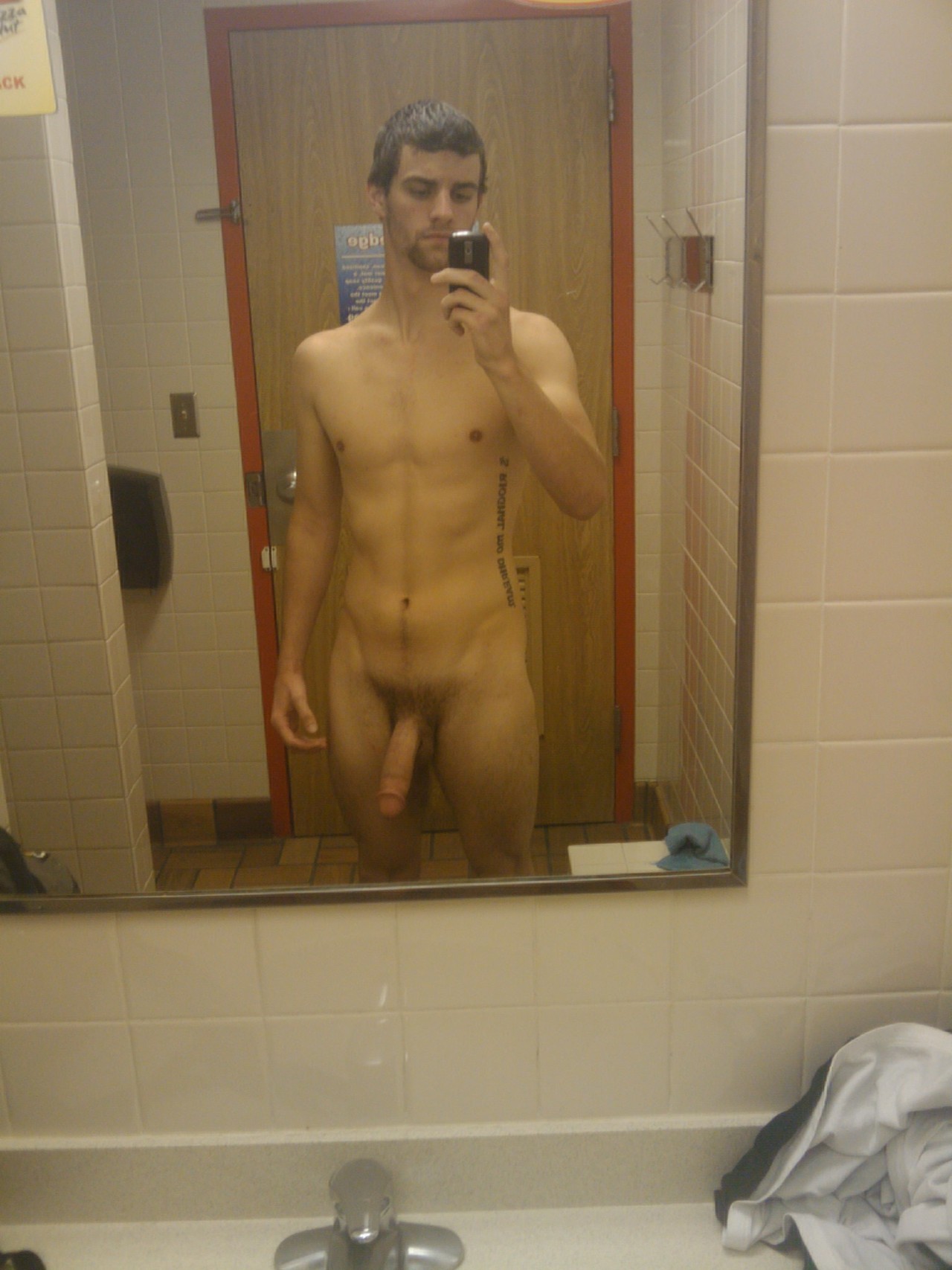 nakedstraightguys:  Awesome nude pic of some hung guy in a public bathroom. Nice