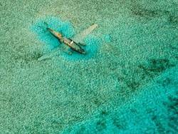 abandonedography:  While island hopping around the Bahamas in a Cessna C172 aircraft, I made this aerial of a Curtiss C-46 that ditched on November 15, 1980. It crashed while it was on a drug smuggling mission for the Colombian Medellín drug cartel and