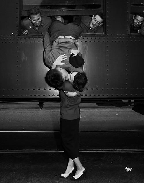  Soldiers leaning out of train windows to kiss their girls goodbye before they left for the war.  