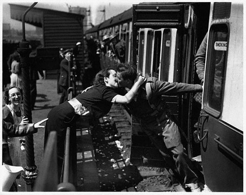  Soldiers leaning out of train windows to kiss their girls goodbye before they left for the war.  