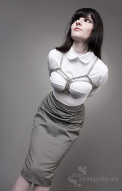 ninh:  Pencil skirt and a tight white blouse, enhanced by rope. I approve. 
